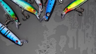 Colorful Fishing Lures on black glass background