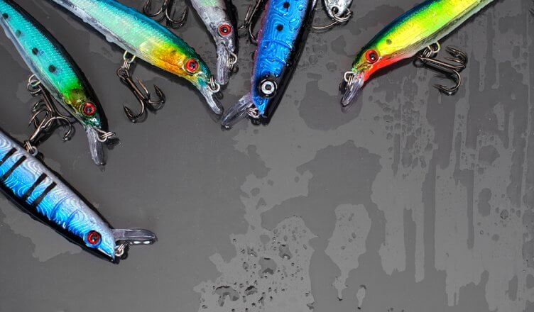 Colorful Fishing Lures on black glass background